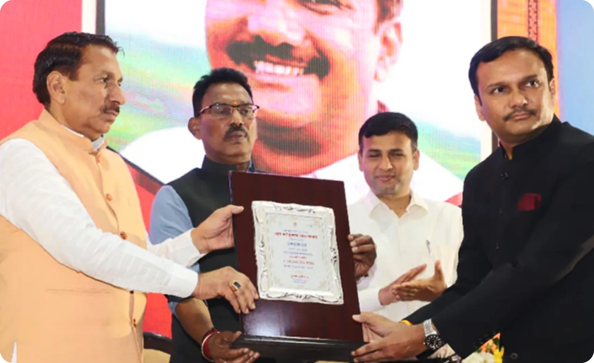 Mr. Vikas Rajoria receiving the state-level excellence award and citation on stage