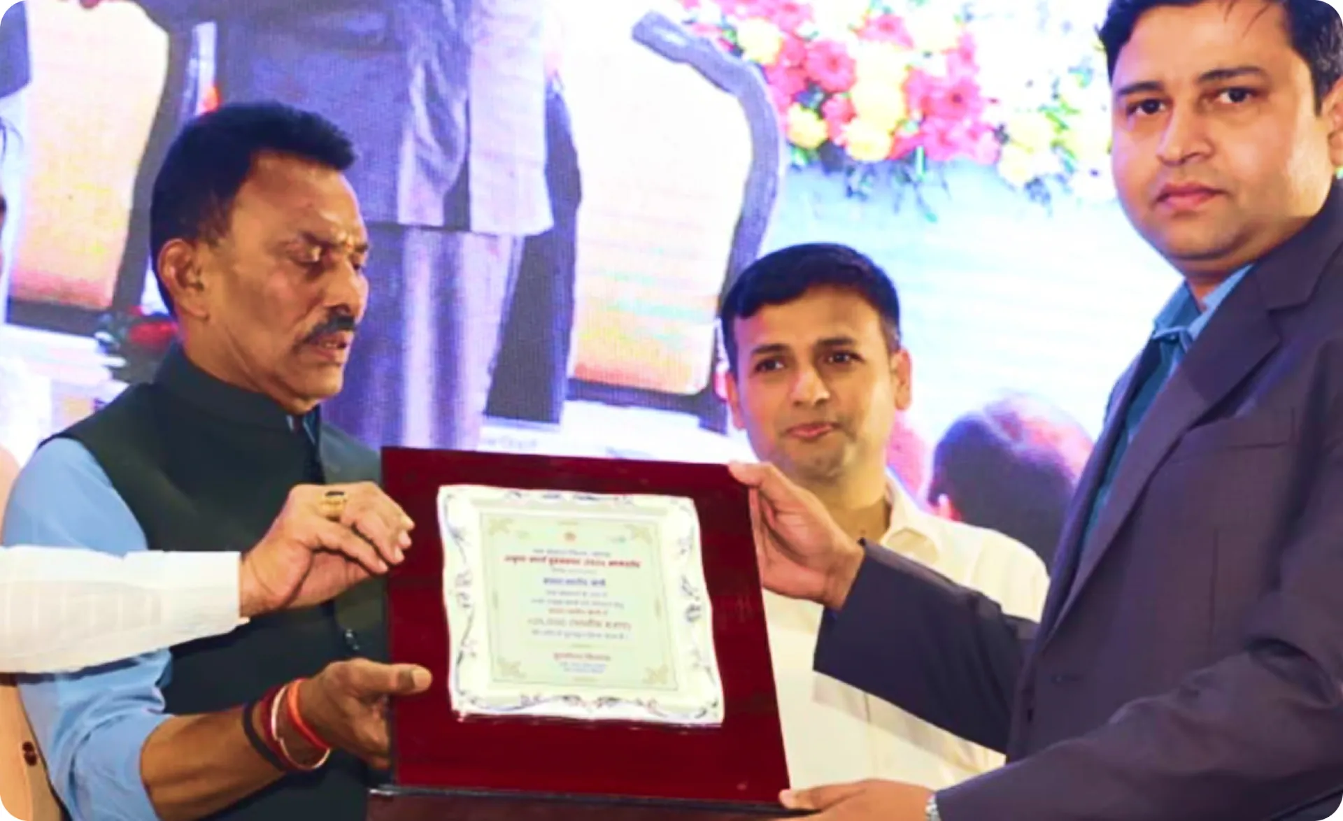 Mr. Sandeep Dubey receiving the basin-level excellence award plaque