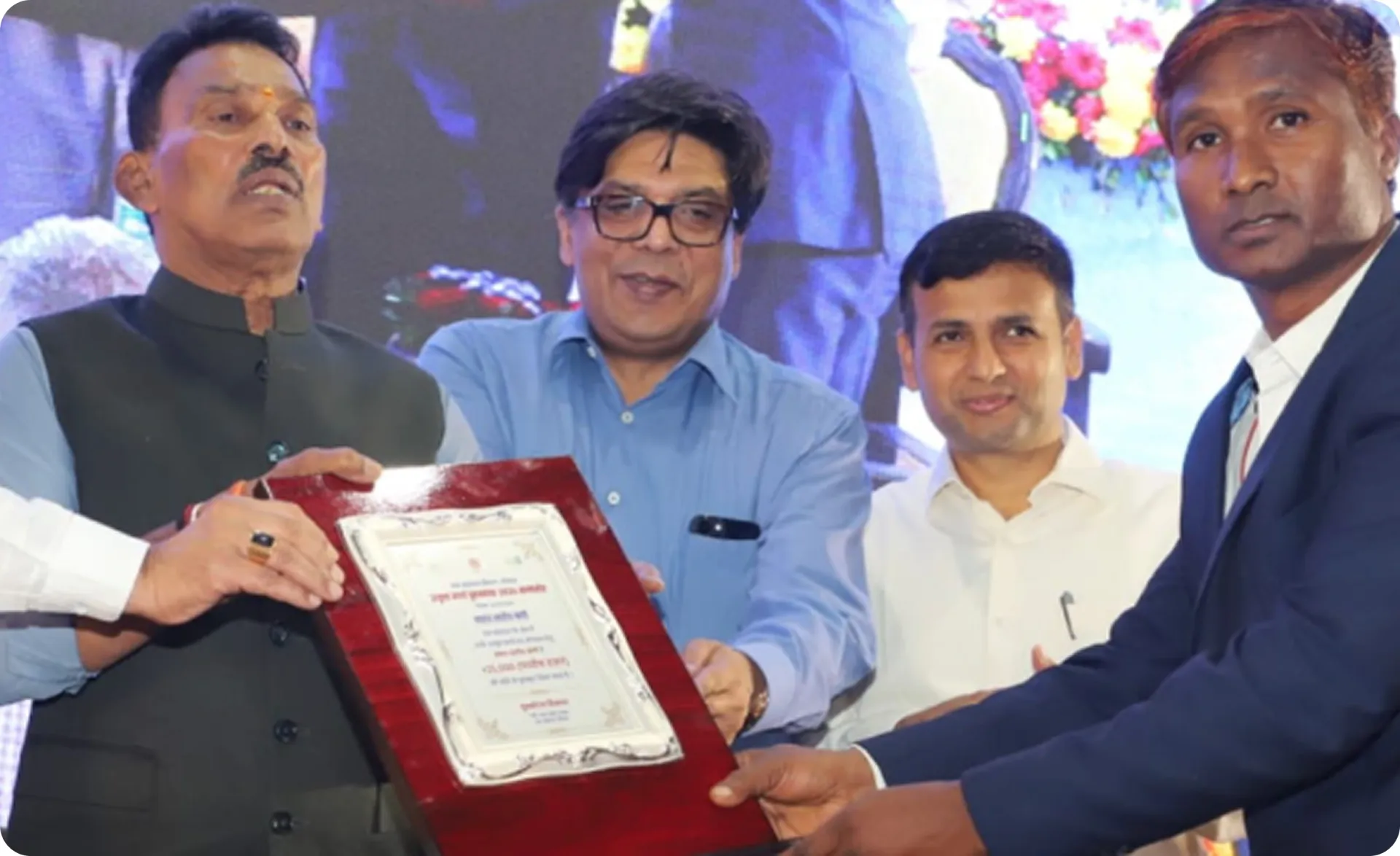 Mr. Kamta Prasad Kadium receiving the basin-level excellence award plaque