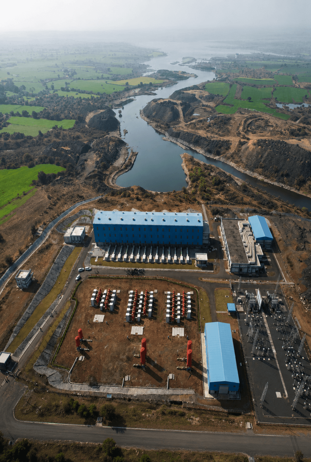 Aerial view of the dam reservoir and pumping station beside the river